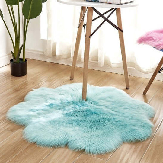 Fluffy aqua blue artificial woolen carpet rug under a table, perfect for cozy and stylish home decor.
