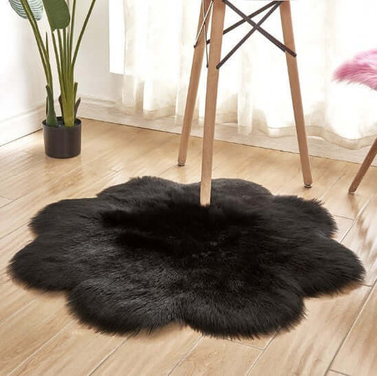 Fluffy black artificial woolen carpet rug in a modern living space under a chair.
