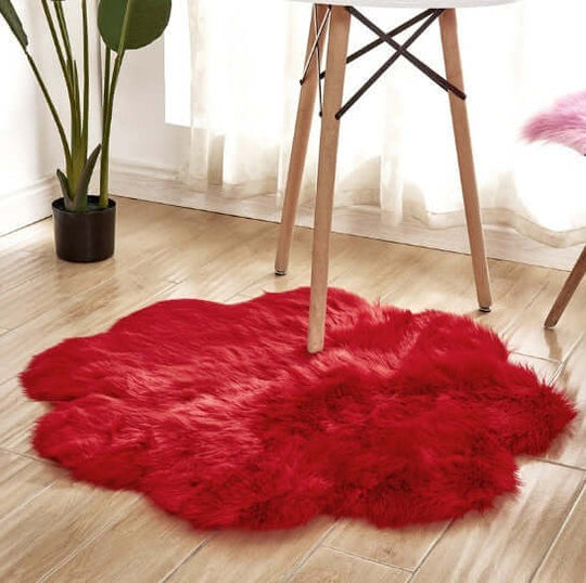 Artificial woolen carpet rug in vibrant red, featuring plush fabric for a warm and cozy aesthetic.
