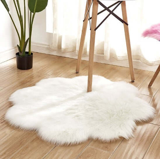 Soft artificial woolen carpet rug placed under a table, featuring a plush, fluffy texture in a bright room.