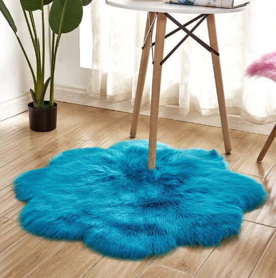Vibrant blue artificial woolen carpet rug, plush fabric, perfect for warm and cozy home decor.