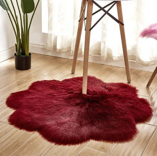 Red plush artificial woolen carpet rug under a table, adding warmth and style to home decor.