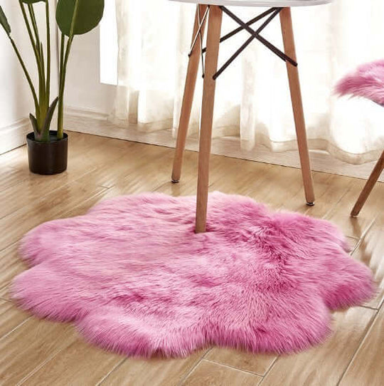 Artificial woolen carpet rug in soft pink, plush fabric perfect for cozy home decor, ideal for adding warmth to any room.