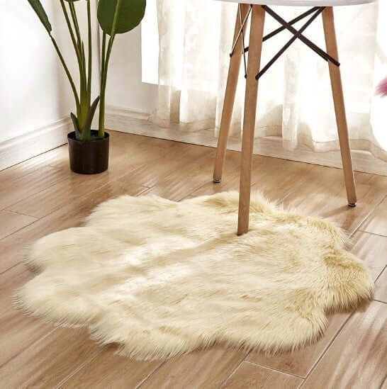 Soft artificial woolen carpet rug in cream color under a table, enhancing interior decor with plush fabric texture.