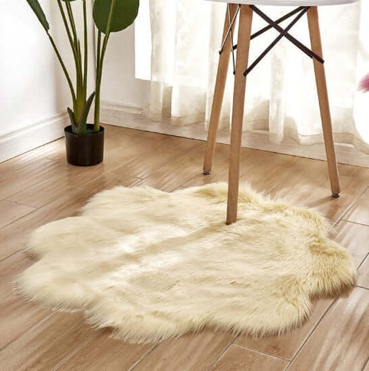Soft artificial woolen carpet rug in cream color under a table, enhancing interior decor with plush fabric texture.